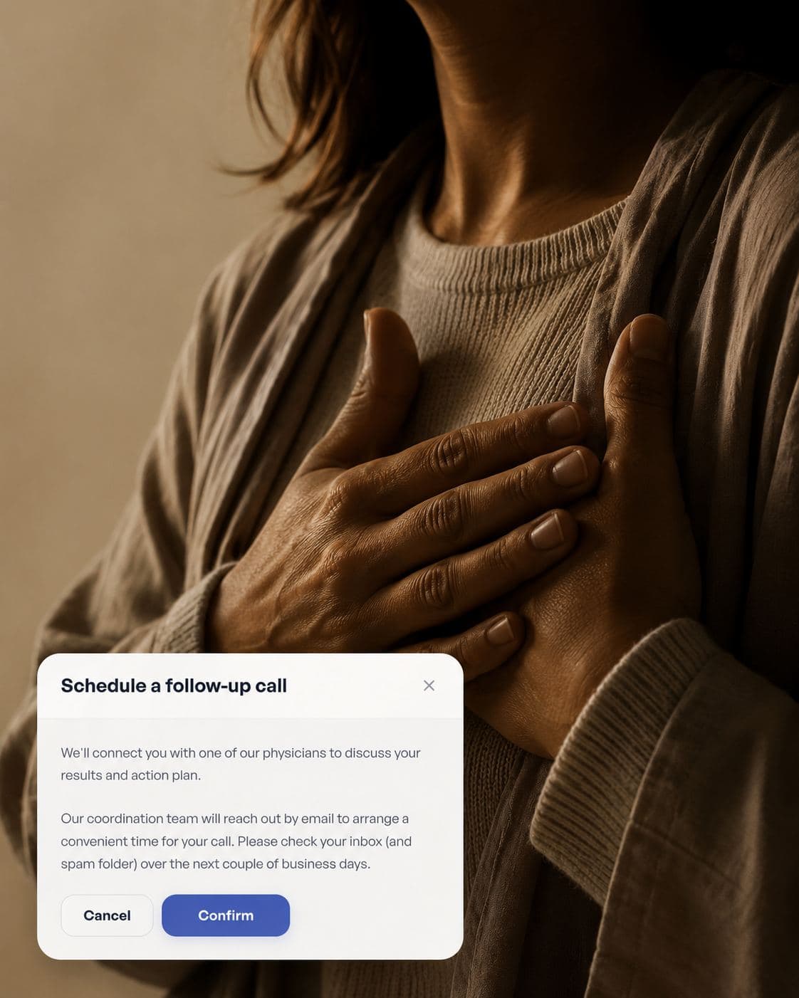 A woman with a hand resting on her chest, with a follow-up call prompt from the Numia app overlaid