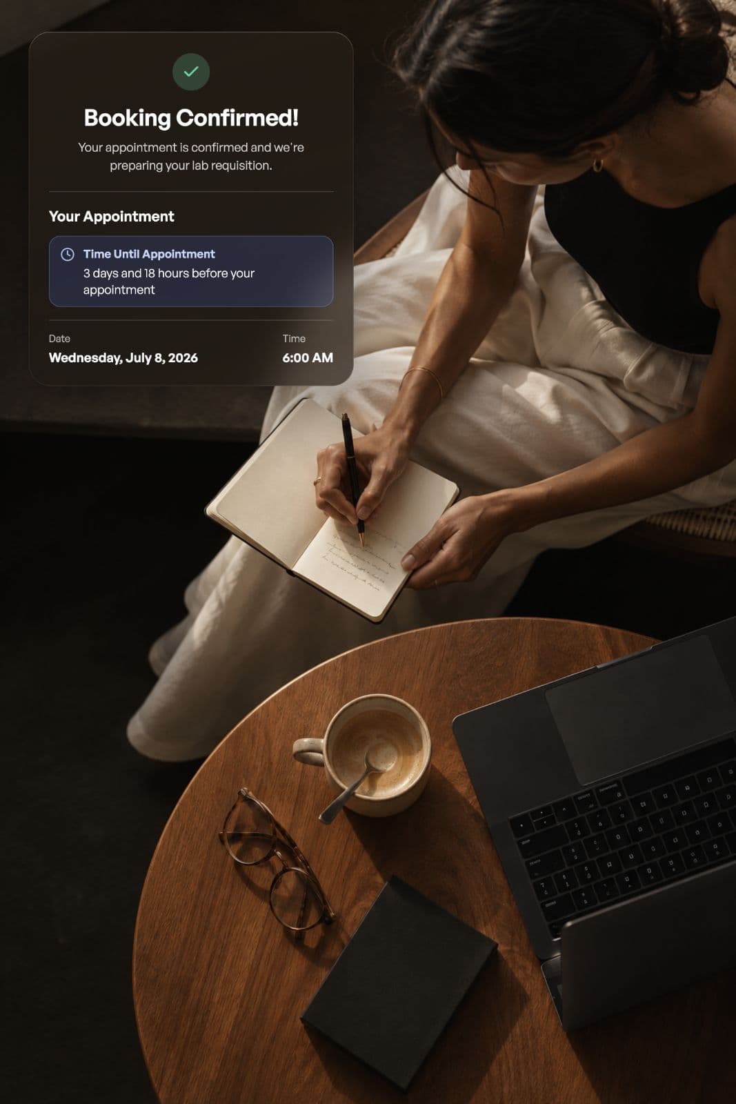 A woman writing in a notebook beside her booking confirmation in the Numia app