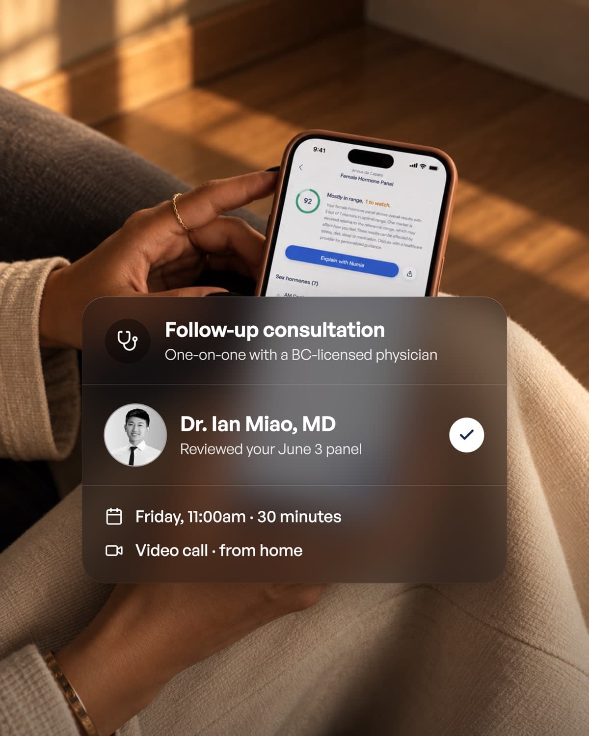 A woman holding her phone with a booked follow-up consultation with a Numia physician
