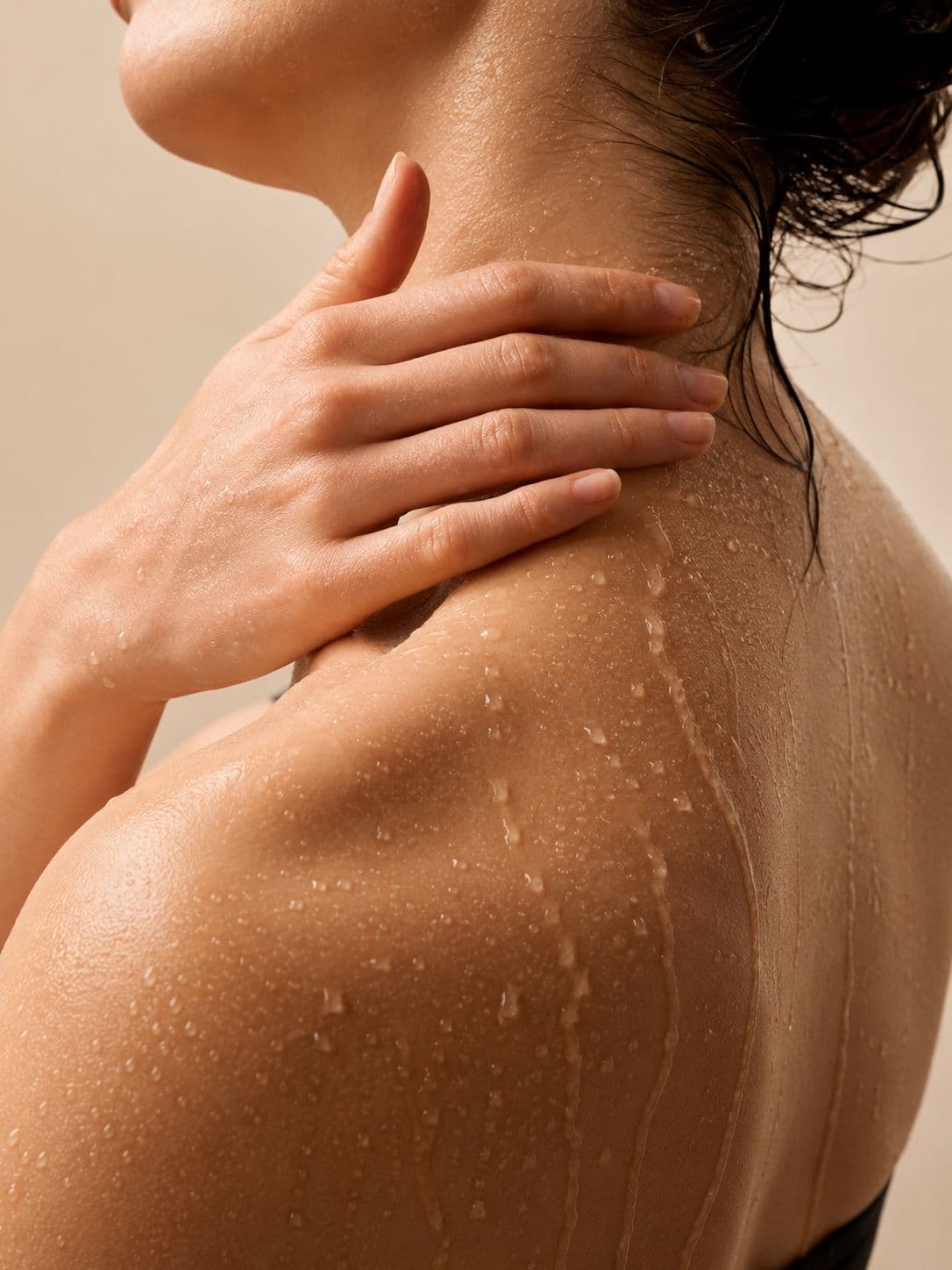 Close-up of a woman's neck and shoulder in warm sunlight
